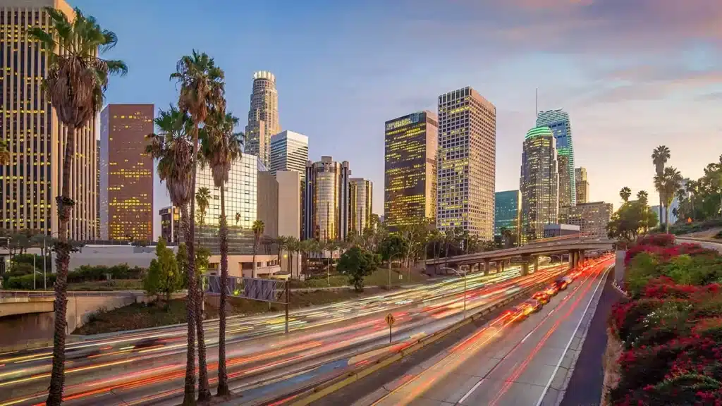 downtown Los Angeles skyline and traffic with palm trees